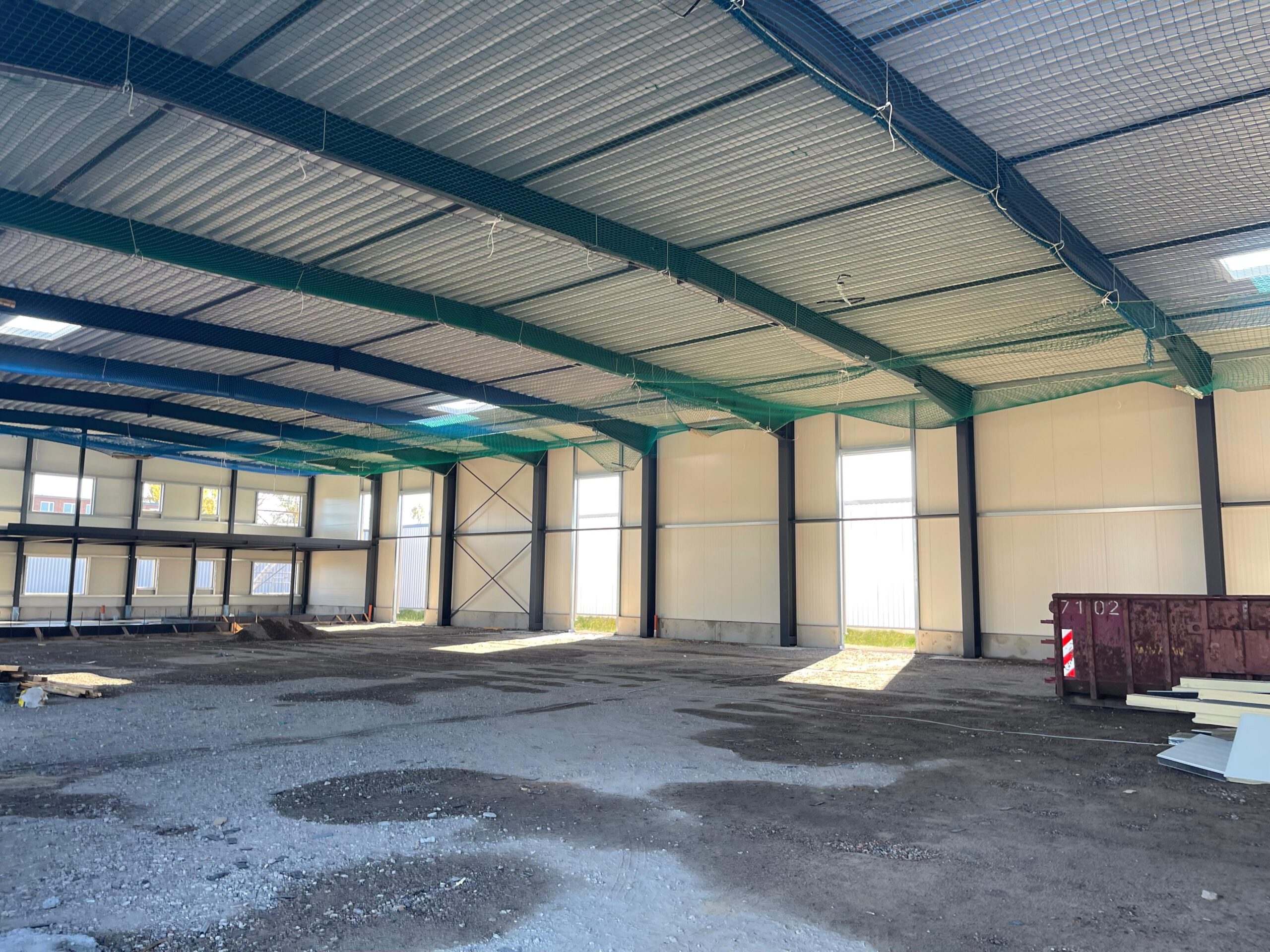 MIBS Real Estate Investment Experts Spacious interior of a 1200sqm industrial office designed for European Network Services GmbH.